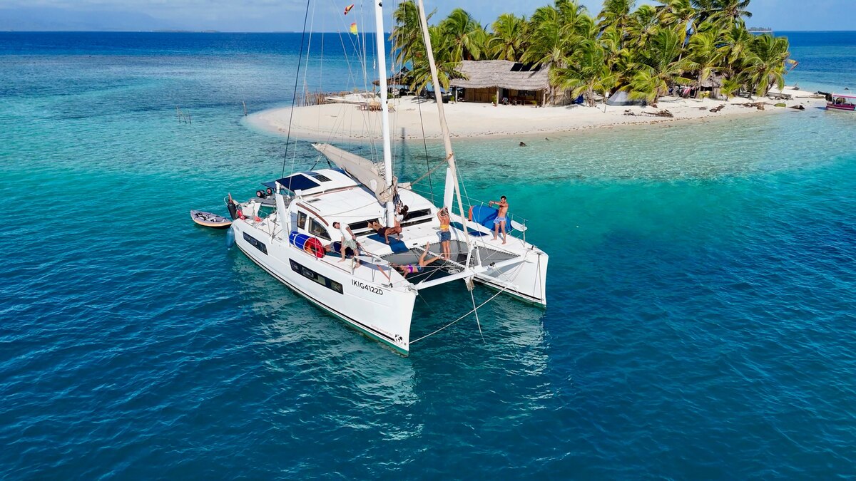 Ikigai anchored off a white-sand beach island