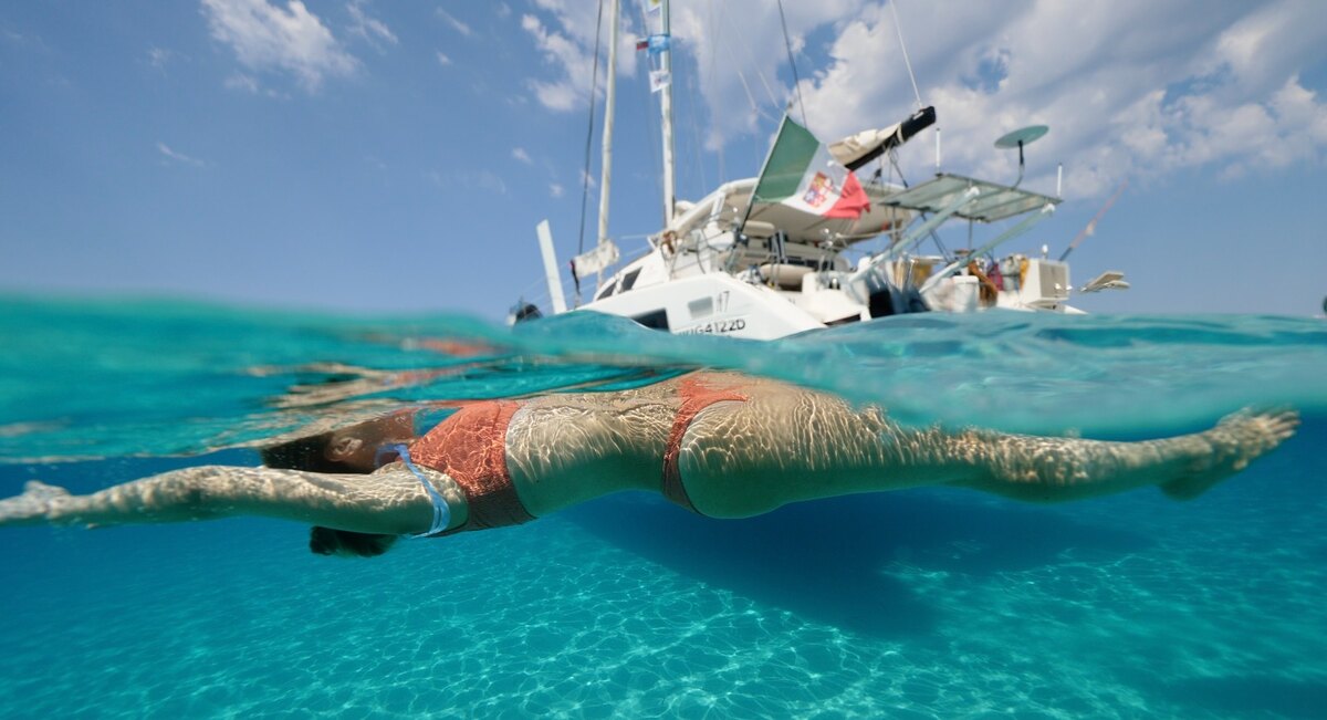 Freediver at the surface beside the catamaran