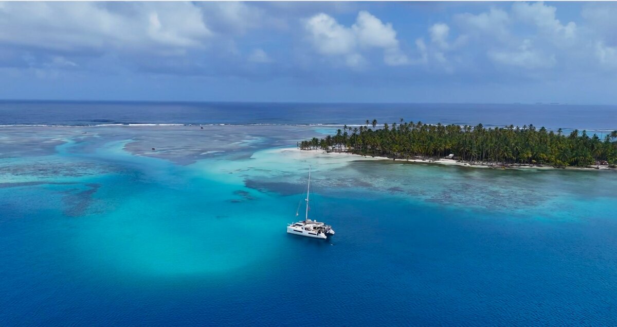 Catamaran among the turquoise reefs of San Blas